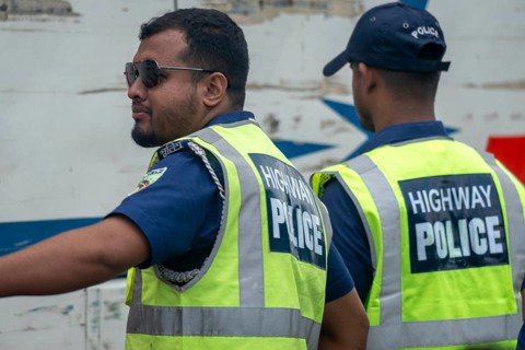 Two highway police officers in reflective vests coordinating together, Dhaka, Bangladesh