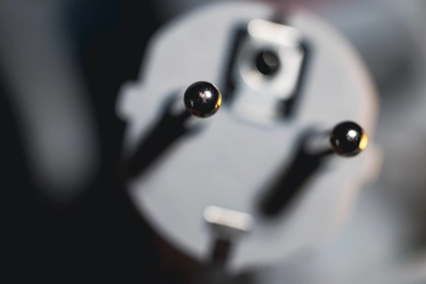 Close-up of a power plug, Schuko plug, with focus on the contact pins, symbol image for,