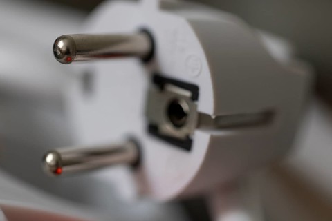 Close-up of a power plug, Schuko plug, with focus on the contact pins, symbol image for,