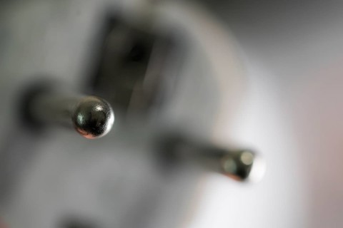Close-up of a power plug, Schuko plug, with focus on the contact pins, symbol image for,