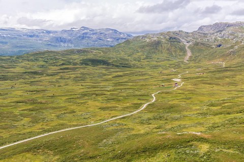 Gravel road through Jotunheimen National Park, view from Smørkollen mountain, Beitostølen,