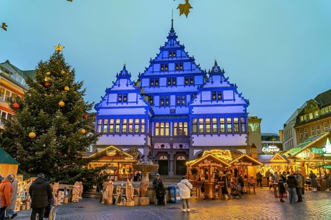 Christmas market at the colourfully illuminated Paderborn Town Hall at duskin Paderborn, North