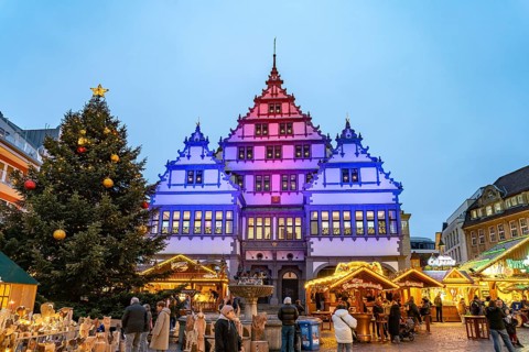 Christmas market at the colourfully illuminated Paderborn Town Hall at duskin Paderborn, North