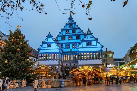 Christmas market at the colourfully illuminated Paderborn Town Hall at duskin Paderborn, North