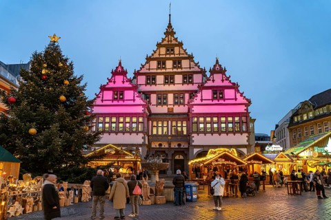 Christmas market at the colourfully illuminated Paderborn Town Hall at duskin Paderborn, North