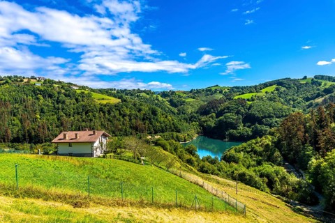 Surrounded by green rolling hills and lush forests, the tranquil ibiur reservoir features a