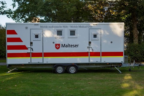 Borken, NRW, Germany, Mobile medical unit from malteser parked on grass, ready to offer medical