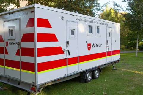 Borken, NRW, Germany, Mobile medical trailer of malteser parked on a lawn, offering medical aid and