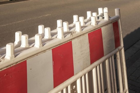 Borken, NRW, Germany, Red and white striped traffic barrier standing on a city street, ensuring