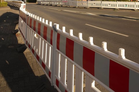 Borken, NRW, Germany, Red and white traffic barriers lining a paved road, guiding traffic flow and