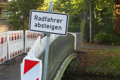 Borken, NRW, Germany, Cyclists dismount sign and construction barriers blocking access to a small