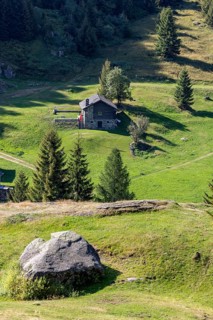 Settlement at mountain huts with boulder, Ör da Pü, Blenio, Ticino, Switzerland