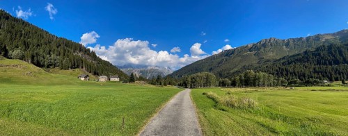 Small road and mountain huts in high valley, Campra, Lukmanier Pass, Blenio, Ticino, Switzerland