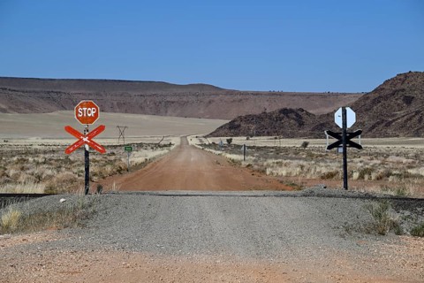 Stop signs at an ungated level crossing on the Lüderitz-Keetmanshoop railway line, near Goageb,