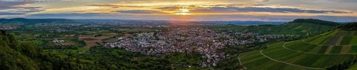 Vineyards and town in front of an impressive sunset under a dramatic sky, Korb im Remstal,