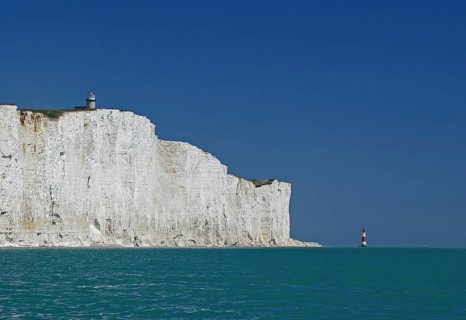 White cliffs with lighthouse under blue sky and turquoise sea, Beachy Head Lighthouse, Bournemouth,