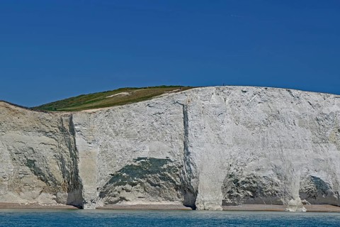 White cliff landscape with blue sky and calm sea, Old Harrys Rock, Beachy Head Lighthouse,