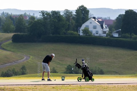 Golfer teeing off, golf course, Jessheim, UIllensaker, Akershus county, Norway