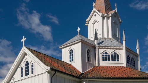 Close-up, white church building with tiled roofs, Tangen kirke or church, Olavsweg or Olavsleden,