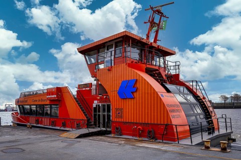 Hapag Lloyd ferry in orange, hvv ferry station at Dockland, fishing harbour, Hamburg, Germany