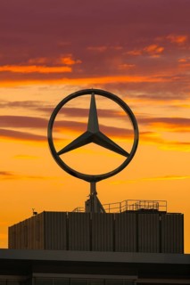 Large Mercedes-Benz logo in front of a dramatic sunset, Stuttgart, Baden-Württembwerg, Germany
