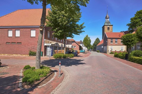 Street, general development, clinker brick building, pointed roof with red roof tiles, church tower