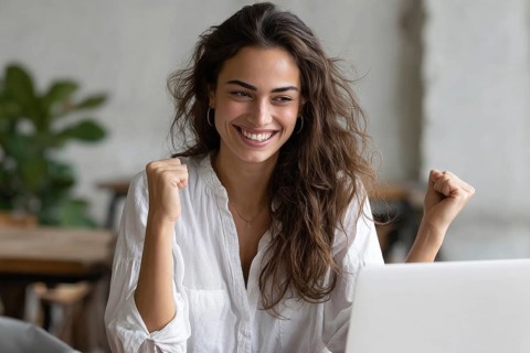 Emotional business woman showing happiness. Concept of winning and achieving corporate goals and