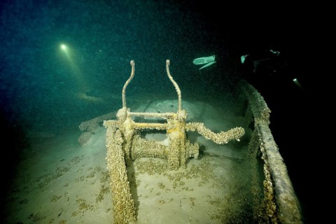 Gloomy shipwreck in Lake Constance, illuminated by rays of light and overgrown with quagga triangle