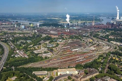 Aerial view, goods train station, thyssenkrupp Steel Europe factory premises, river Rhine with