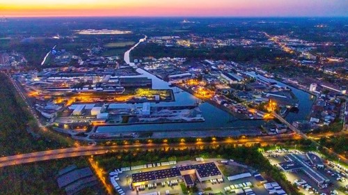 Aerial view, night view of Dortmund harbour, historical building old harbour office, container