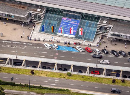 Aerial photo, Dortmund airport, departure level, arrival right of way, flags at airport entrance,