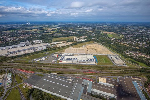 Aerial view, construction site with the new REWE logistics centre on Walzwerkstraße at the old