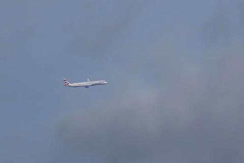 Boeing 787-9 Dreamliner jet passenger aircraft of British Airways airlines in flight in a blue sky,