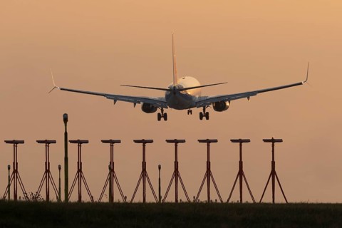 Boeing 737 jet aircraft of Ryanair airlines in flight landing at sunset at London Stansted airport,