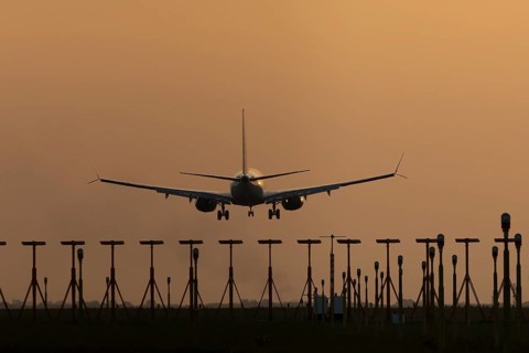 Boeing 737 jet aircraft of Ryanair airlines in flight landing at sunset at London Stansted airport,
