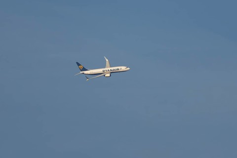 Boeing 737 jet passenger aircraft of Ryanair airlines in flight in a blue sky, Rome, Italy