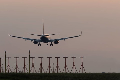 Boeing 737 jet aircraft of Ryanair airlines in flight landing at sunset at London Stansted airport,