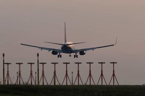 Boeing 737 jet aircraft of Ryanair airlines in flight landing at sunset at London Stansted airport,