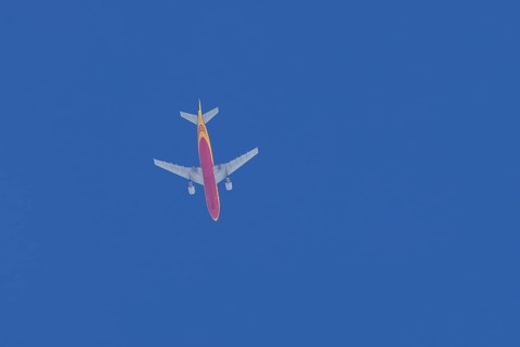 Boeing 767 jet aircraft of DHL cargo airlines in flight in a blue sky, England, United Kingdom