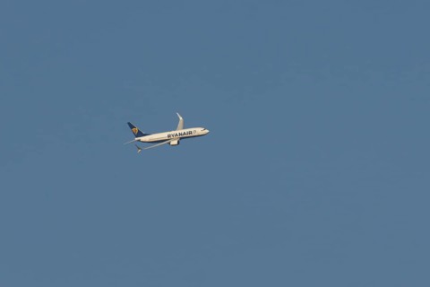 Boeing 737 jet passenger aircraft of Ryanair airlines in flight in a blue sky, Rome, Italy
