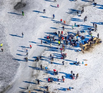 Aerial view, ice rink, ice skaters and pedestrians on frozen Rhine meadow in Lörrick near the