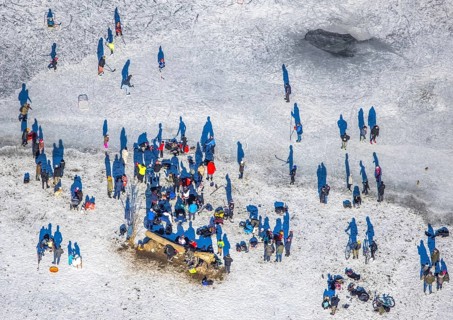 Aerial view, ice rink, ice skaters and pedestrians on frozen Rhine meadow in Lörrick near the