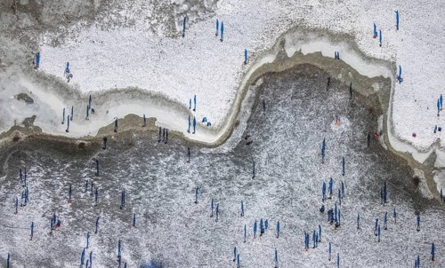 Aerial view, ice rink, ice skaters and pedestrians on frozen Rhine meadow in Lörrick near the