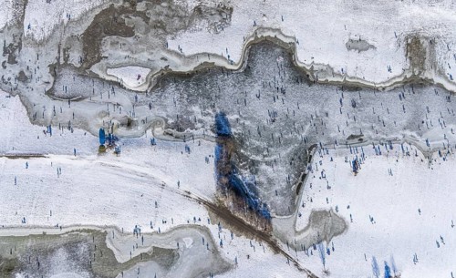 Aerial view, ice rink, ice skaters and pedestrians on frozen Rhine meadow in Lörrick near the
