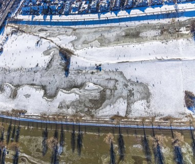Aerial view, ice rink, ice skaters and pedestrians on frozen Rhine meadow in Lörrick near the