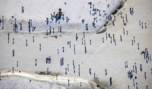 Aerial view, ice rink, ice skaters and pedestrians on frozen Rhine meadow in Lörrick near the