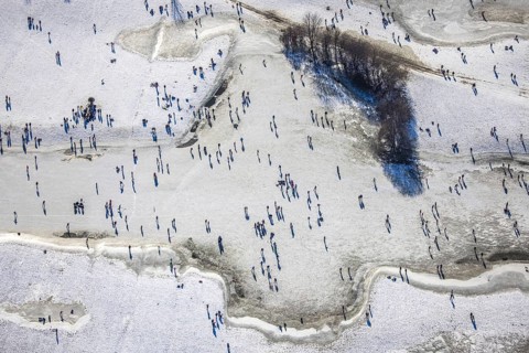 Aerial view, ice rink, ice skaters and pedestrians on frozen Rhine meadow in Lörrick near the