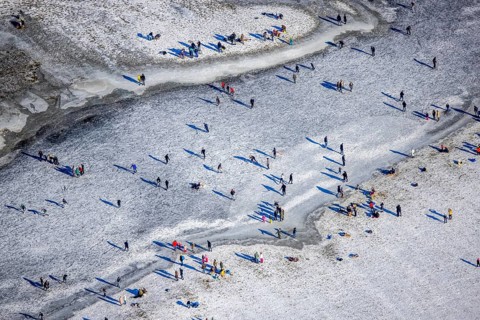 Aerial view, ice rink, ice skaters and pedestrians on frozen Rhine meadow in Lörrick near the