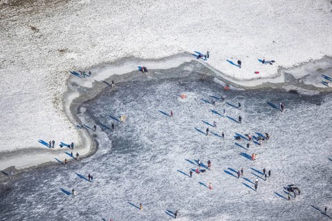 Aerial view, ice rink, ice skaters and pedestrians on frozen Rhine meadow in Lörrick near the