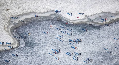 Aerial view, ice rink, ice skaters and pedestrians on frozen Rhine meadow in Lörrick near the